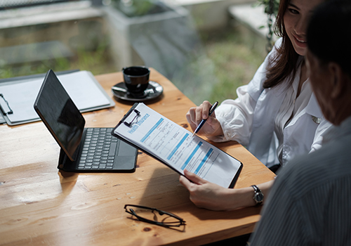 Doctor shows patient forms for BCBS FEP Insurance coverage