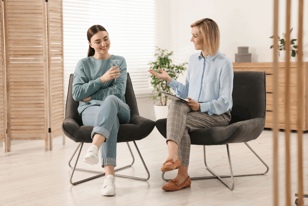 Teen sitting with a therapist in a supportive counseling session – choosing between CBT and DBT for teen mental health.