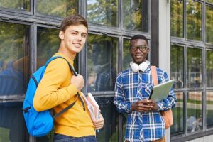 Happy teen students walking out of school after receiving mental health support.
