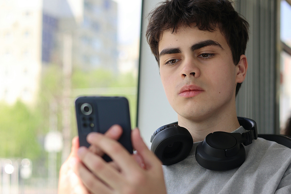 Parent worried as teen withdraws emotionally, representing warning signs of ADHD and substance use.