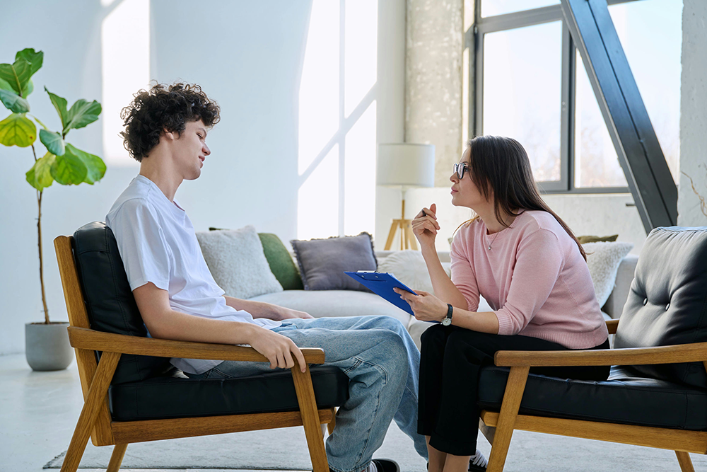 Teen speaking with a mental health counselor for emotional support.